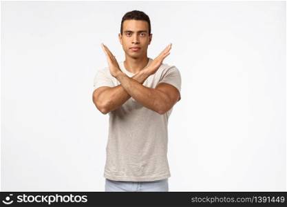 Time to stop. Serious-looking strong calm young masculine male athlete making cross with arms over chest look straight camera with determined, assertive expression, prohibit alcohol, white background.. Time to stop. Serious-looking strong calm young masculine male athlete making cross with arms over chest look straight camera with determined, assertive expression, prohibit alcohol, white background