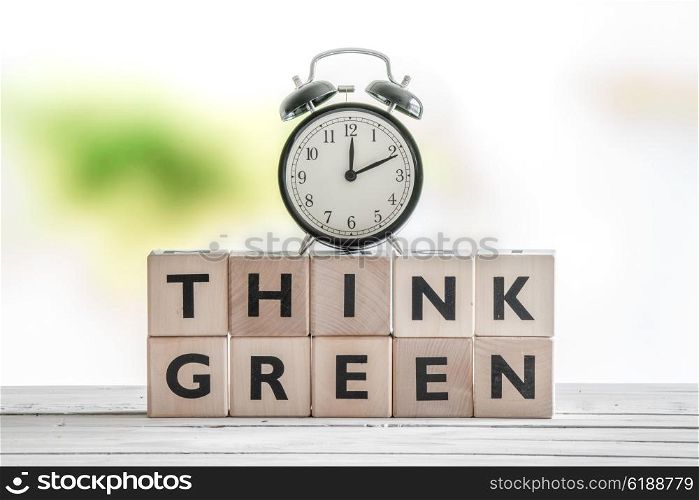 Time to think green sign on a wooden table
