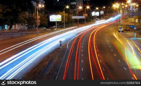 timelapse busy traffic on road in city at night