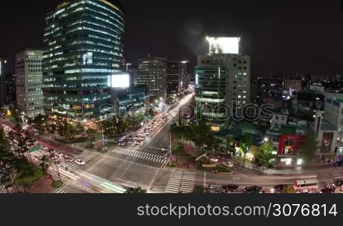 Timelapse high angle shot of night metropolis Seoul in South Korea. Illuminated buildings and busy city motorways