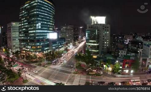 Timelapse high angle shot of night metropolis Seoul in South Korea. Illuminated buildings and busy city motorways