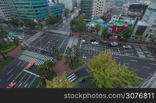 Timelapse high angle shot of transport traffic on junction in capital city Seoul, South Korea. Road marked with zebra crossings