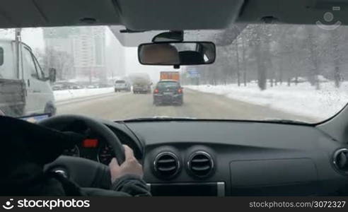 Timelapse of everyday driving in big city. Melting and dirty snow on the road