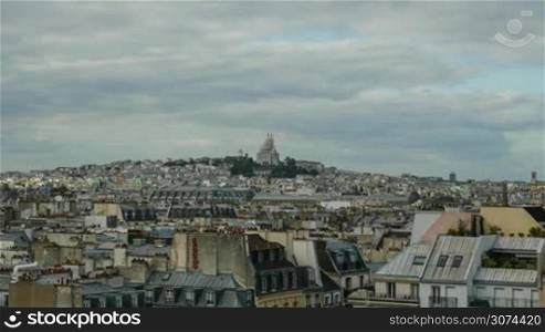 Timelapse panoramic shot of Paris with zooming in the sunlit Sacre Coeur Basilica and crowd of people there