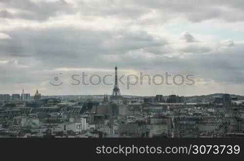 Timelapse shot of clouds piling up over the Paris as the evening comes. Panoramic shot of the city with the Eiffel Tower in centre