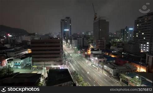 Timelapse shot of metropolis at night. Cityscape with cars driving on highway. Seoul, Republic of Korea