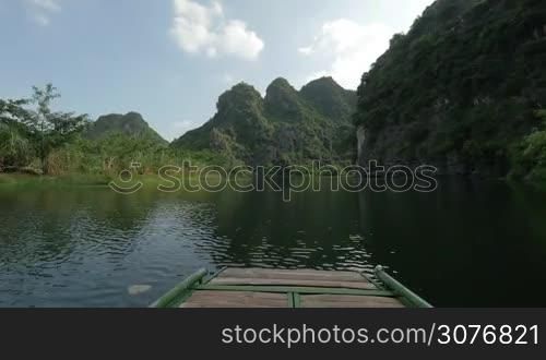 Timelapse shot of river boat tour among the limestone mountains in Trang An Landscape Complex, Vietnam