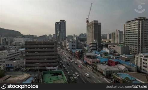 Timelapse shot of Seoul city life, Republic of Korea. Street with busy car traffic, construction of highrise building and clouds sailing over metropolis