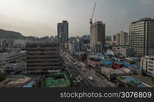 Timelapse shot of Seoul city life, Republic of Korea. Street with busy car traffic, construction of highrise building and clouds sailing over metropolis