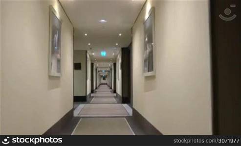 Timelapse steadicam shot of moving forward in the hotel corridor. Light and modern design