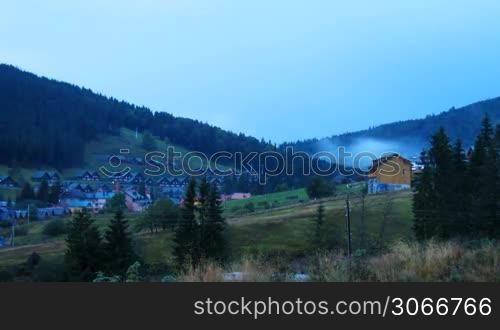 timelapse sunset in Carpathian mountains summer, cottages of resort Bukovel, Ukraine