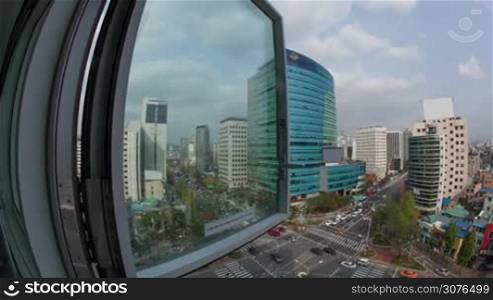 Timelapse wide angle shot of city panorama with intense car traffic on the streets. View from the window to Seoul, South Korea