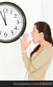 Timing - Surprised face expression businesswoman casual looking at clock