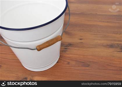 Tin bucket on wood
