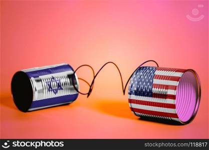 tin can phone with USA and Israel flags.communication concept on pink. tin can phone with USA and Israel flags .communication concept. tin can phone with USA and Israel flags .communication concept