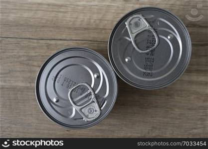 Tin cans for food on wooden background. Top View.