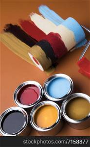 Tin metal cans with color paint and paintbrush