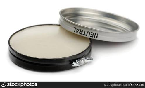 Tin of neutral shoe polish isolated on white