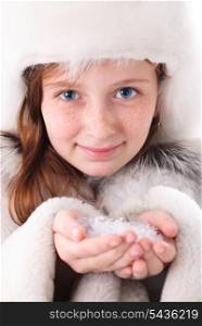 Tinage girl in fur coat and closeup hands with snow