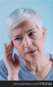Tinnitus. Senior Woman Suffering From Tinnitus.