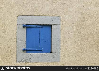 Tiny Blue Door in White Wall
