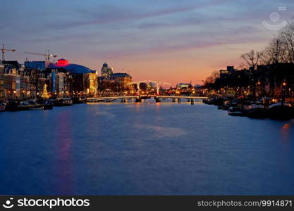 Tiny bridge in Amsterdam the Netherlands at sunset at the Amstel