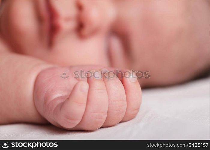 Tiny fingers of newborn baby closeup