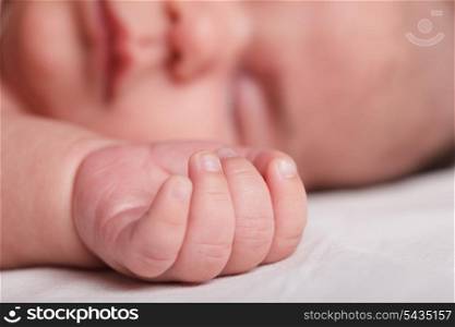 Tiny fingers of newborn baby closeup