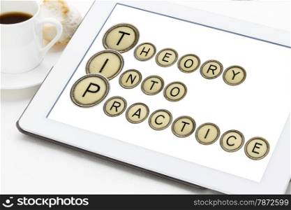 TIP (theory into practice) acronym explained with old typewriter keys on a digital tablet with a cup of coffee