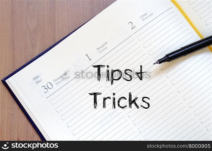 Tips and tricks text concept write on notebook with pen