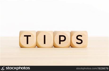TIPS word on wooden blocks on table. Copy space