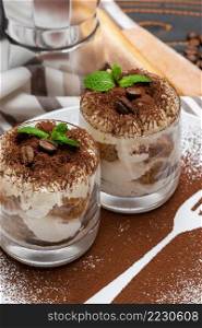 tiramisu dessert cooking - Traditional Italian Savoiardi ladyfingers Biscuits and cream in glass baking dish on concrete background or table. tiramisu dessert cooking - Traditional Italian Savoiardi ladyfingers Biscuits and cream in glass baking dish on concrete background