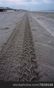 tire tracks on beach closeup
