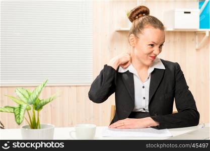 tired accountant rubbing sore neck in the office