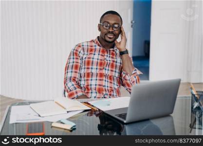 Tired african american male worker with closed eyes hold head with hand relax, have a break at workplace. Pensive black man at laptop collect thoughts together before work to increase productivity.. Tired african american man closed eyes holding head by hand have a break at workplace at laptop