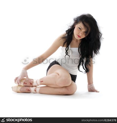 tired ballet dancer with wounded feet over white