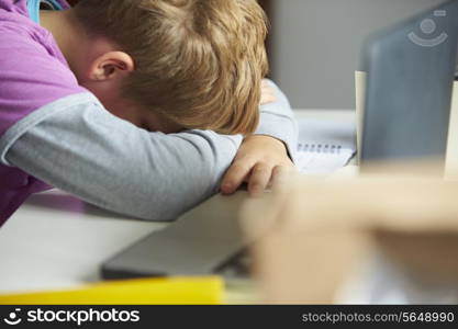 Tired Boy Studying In Bedroom