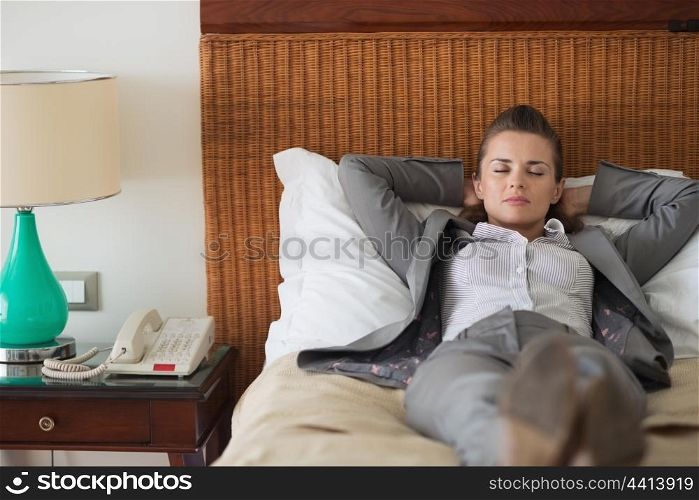 Tired business woman sleeping in hotel room