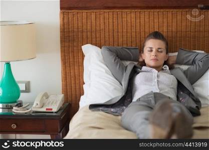 Tired business woman sleeping in hotel room