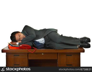 Tired Businessman Having A Sleep On A Desk In His Office