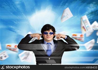 Tired businessman. Image of businessman stopping his ears. Long working hours