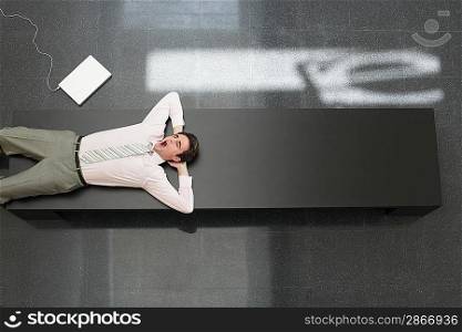 Tired Businessman Lying Down on Desk