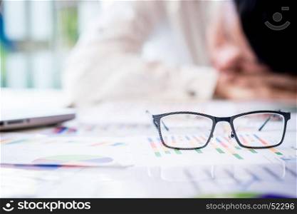 tired businessman sleeping while calculating expenses at desk in office.