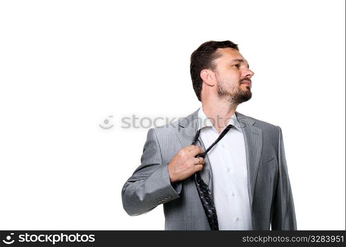 Tired businessman taking off his tie. Tired businessman taking off his tie. Isolated on white.