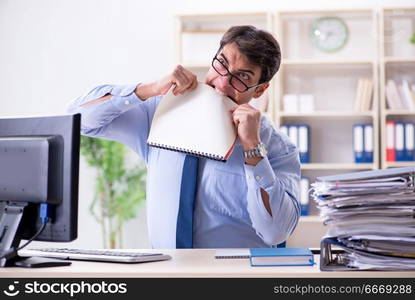 Tired businessman with too much paperwork