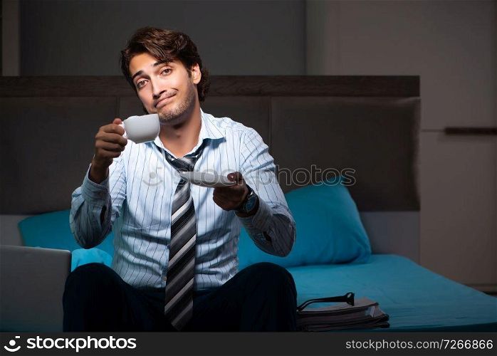 Tired businessman working overtime at home at night