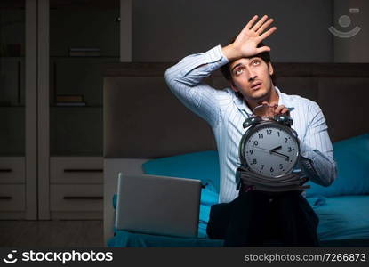 Tired businessman working overtime at home at night