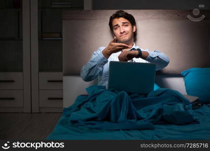 Tired businessman working overtime at home at night
