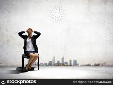 Tired businesswoman. Image of depressed businesswoman sitting on chair