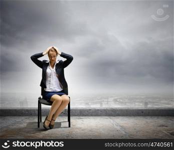 Tired businesswoman. Image of depressed businesswoman sitting on chair